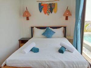 a bedroom with a bed with two towels on it at Summer Villa with 3 Bedrooms in Phu Quoc +22 photos