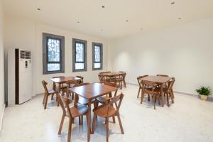 a dining room with wooden tables and chairs at Yangshuo Hidden Dragon Villa in Yangshuo