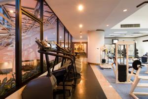 a gym with treadmills and elliptical machines at Montien Riverside Hotel Bangkok in Bangkok