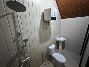 a small bathroom with a toilet and a sink at Royal Indah Glamping Kintamani in Kintamani +13 photos