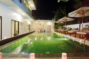 a swimming pool in a villa with tables and chairs at Sam So Boutique Villa in Siem Reap