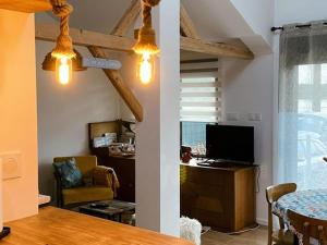 a living room with a table and a dining room at Maison au bord du lac pour 4 pers. + enfants, nature et tranquillité, animaux admis - FR-1-589-803 in Sanchey