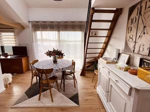 a dining room with a table and chairs in a kitchen at Maison au bord du lac pour 4 pers. + enfants, nature et tranquillité, animaux admis - FR-1-589-803 in Sanchey +27 photos