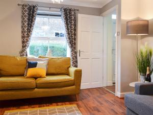 a living room with a couch and a window at The Horseshoes in Hornsea