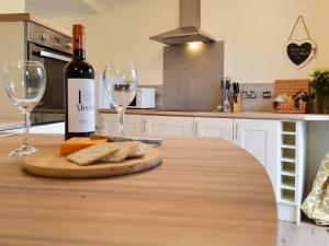 a bottle of wine and cheese on a table with wine glasses at The Horseshoes in Hornsea +15 photos