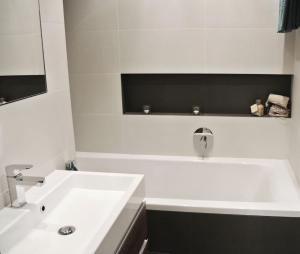 a white bathroom with a sink and a bath tub at Nice room in heart of Arrecife in Arrecife
