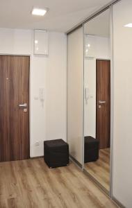 a room with sliding glass doors and a black ottoman at Nice room in heart of Arrecife in Arrecife
