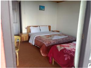 a small bedroom with a bed and a chair at Yankee Village Retreat Reshop in Lava