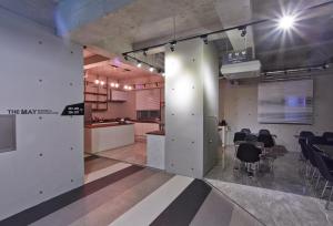 a large room with a table and chairs in it at Hotel The May in Gwangju