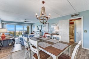 a dining room and living room with a table and chairs at N1 Amelia South apts in Fernandina Beach