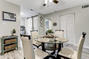 a dining room with a glass table and chairs at 3E Amelia Landings condo in Fernandina Beach