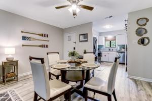 a dining room and kitchen with a table and chairs at 3E Amelia Landings condo in Fernandina Beach