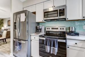 a kitchen with stainless steel appliances and white cabinets at 3E Amelia Landings condo in Fernandina Beach