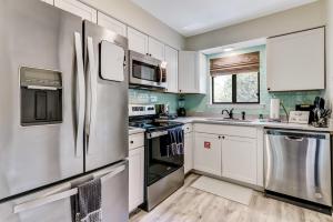 a kitchen with white cabinets and stainless steel appliances at 3E Amelia Landings condo in Fernandina Beach +31 photos
