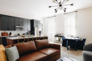 a living room with a couch and a kitchen at The Purple Martin - Nest in Louisville