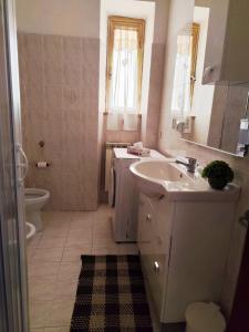 a bathroom with a sink and a toilet at La casa di Lilly in Civitavecchia +26 photos