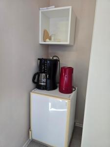 a coffee maker sitting on top of a refrigerator at Bed and Breakfast BLUE in BLUE, Room GREEN + in Komiža +8 photos