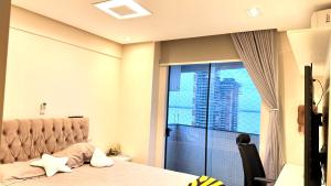 a bedroom with a bed and a large window at Umarizal in Belém +26 photos