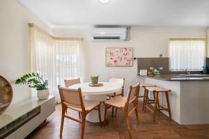 a kitchen and dining room with a table and chairs at Glenelg Hideaway Bliss in Glenelg