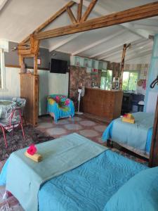 a room with two beds and a tv in it at Cabañas Kitai in Hanga Roa