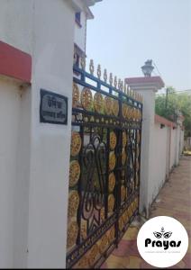 a gate of a building with a sign on it at Udita Homestay Prayas in Shānti Niketan