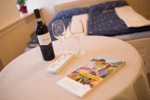 a bottle of wine and two glasses on a table at Apartment historical city in Znojmo