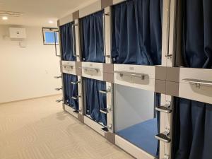 a row of blue curtains in a dressing room at HOTEL PAiKAJi in Ishigaki Island