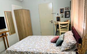 a bedroom with a bed with a dresser and a desk at SERENITY in Beʼer Ora +4 photos