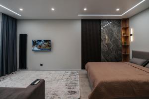 a bedroom with a bed and a couch at ЖК Sun city in Oral