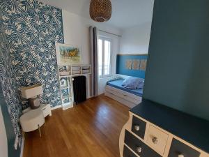 a small bedroom with a bed and a window at La Maisonnée in Marolles
