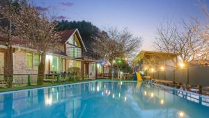 a swimming pool in front of a house at Gapyeong ebenzer Pension in Gapyeong