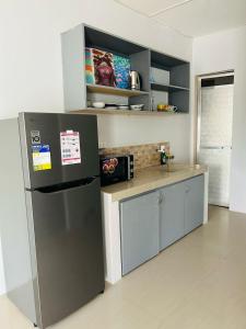 a kitchen with a refrigerator and a counter top at Casa Residence by Baluyut in Concepcion +17 photos
