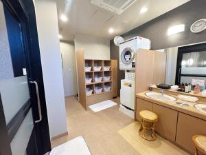 a large bathroom with a sink and a counter at Hotel Route-Inn Iwata Inter in Iwata