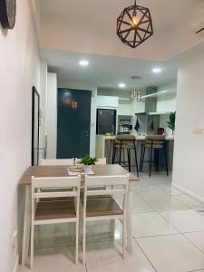 a kitchen and dining room with a table and chairs at Sutera Avenue Homestay , Opposite Imago , Kota Kinabalu in Kota Kinabalu