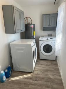 a laundry room with a washing machine and a washer at House in Malvern, AR in Malvern