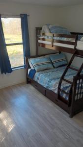 a bedroom with two bunk beds and a window at House in Malvern, AR in Malvern +2 photos