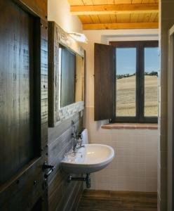 a bathroom with a sink and a window at Villa Vernaschi in Santa Maria Nuova