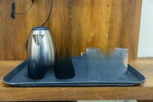 a black and silver vase sitting on a table at Palani Andavar in Bangalore