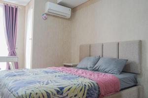 a bedroom with a bed and a air conditioner at Barsa City Babarsari 266 in Yogyakarta