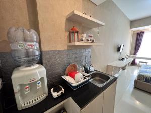 a kitchen counter with a sink and a mixer at Barsa City Babarsari 266 in Yogyakarta