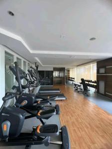 a gym with a bunch of treadms and elliptical machines at Cozy, spacious and well lighted condo in Iloilo City