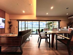a dining room with a table and chairs with a view at the 478 -pool & spa- Miyakojima Luxury Villa in Miyako Island