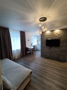 a hotel room with a bed and a brick wall at Bonjour in Narva