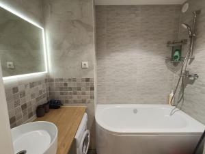 a bathroom with a tub and a toilet and a sink at Bonjour in Narva