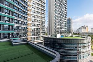 a view of a large building with a green roof at Poly Central Plaza By Boli at Sanya City Center#Near Joy City in Sanya