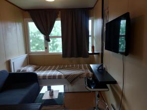 a small room with a couch and a window at Cozy room away from home in Åmot