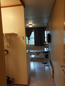 a hallway with a room with a desk and a window at Cozy room away from home in Åmot