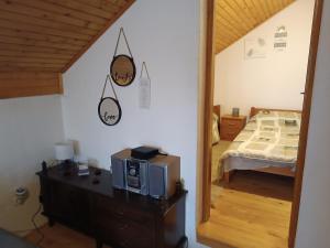 a bedroom with a bed and a microwave on a dresser at Relaks dream in Vlasic