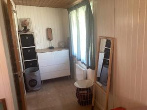 a small room with a mirror and a dresser at 6 person holiday home in Dannemare in Dannemare +83 photos