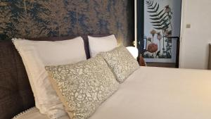 a bed with two pillows on top of it at La maison du Mont Saint Michel in Pontorson +50 photos